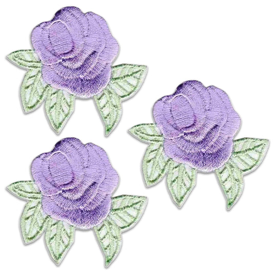 The LaughingLizards Small Pastel Rosebud (3-Pack) Floral Iron On Patch features three charming embroidered rosebuds with green leaves, perfect for adding a floral accent to any fabric project.