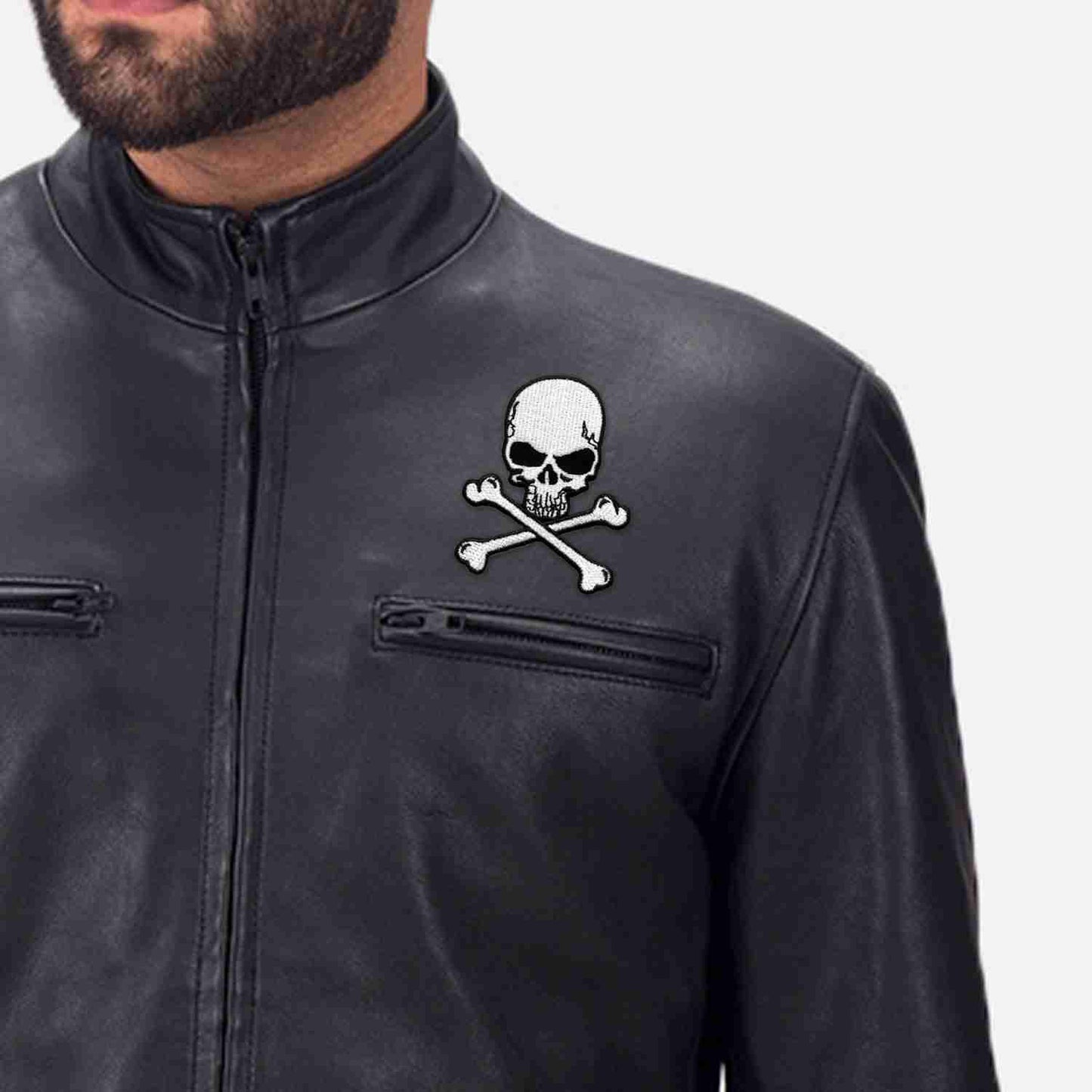 A black leather jacket with Skull and Crossbones Patches (3-Pack) Skull Embroidered Iron On Patch Appliques on it.