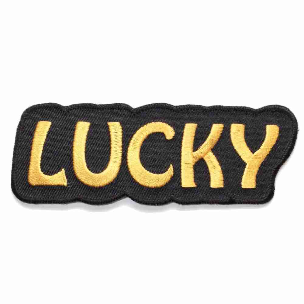 A Lucky Iron On Patch with the word lucky on it.