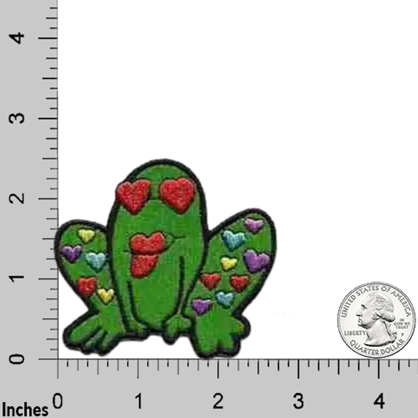 The Laughing Lizards Kissing Heart Frog (3-Pack) Iron on Patch features an embroidered frog with heart shapes, shown with a ruler and quarter for scale—great for kids' clothes or as a cute frog patch.