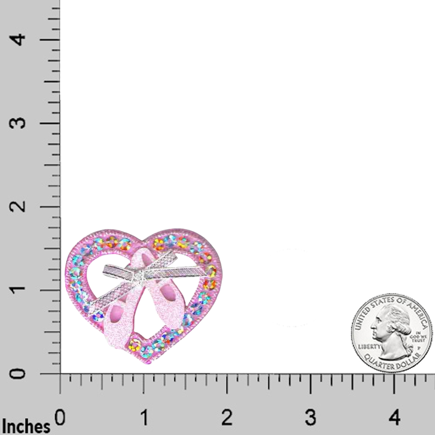 A Ballet Toe Shoes in Sequined Heart (3-Pack) Iron On Patch by Laughing Lizards, featuring a heart shape with glitter ballet shoe details, is shown next to a U.S. quarter and inch ruler for scale.