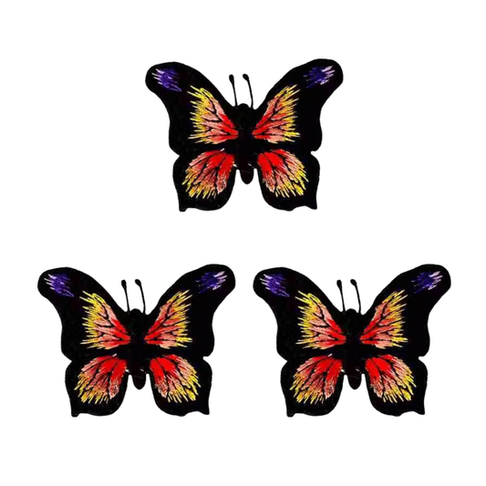 Three LaughingLizards Black, Yellow & Orange Butterfly Iron On Patches (3 Pack) are displayed in a triangular arrangement on a white background.