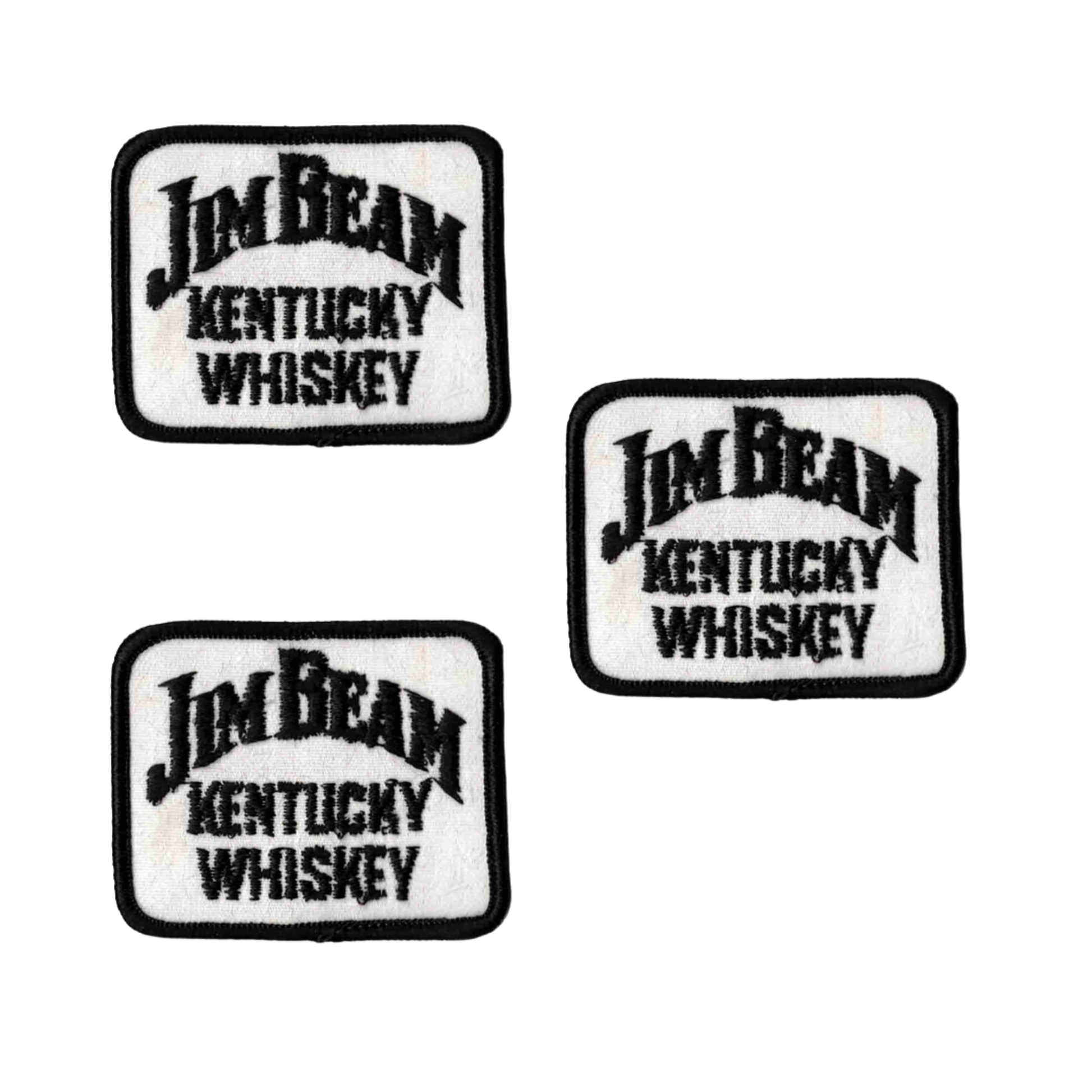 The Laughing Lizards Jim Beam Kentucky Whiskey (3-Pack) Iron on Patch features three rectangular patches with "Jim Beam Kentucky Whiskey" embroidered in black on a white background, each with a black border.