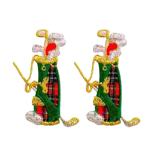 The Laughing Lizards Plaid Golf Bag of Clubs Iron On Sports Patch 2-Pack features embroidered green golf bags with red, black, and gold details—perfect for adding sporty flair to clothing or accessories. Set against a white background.