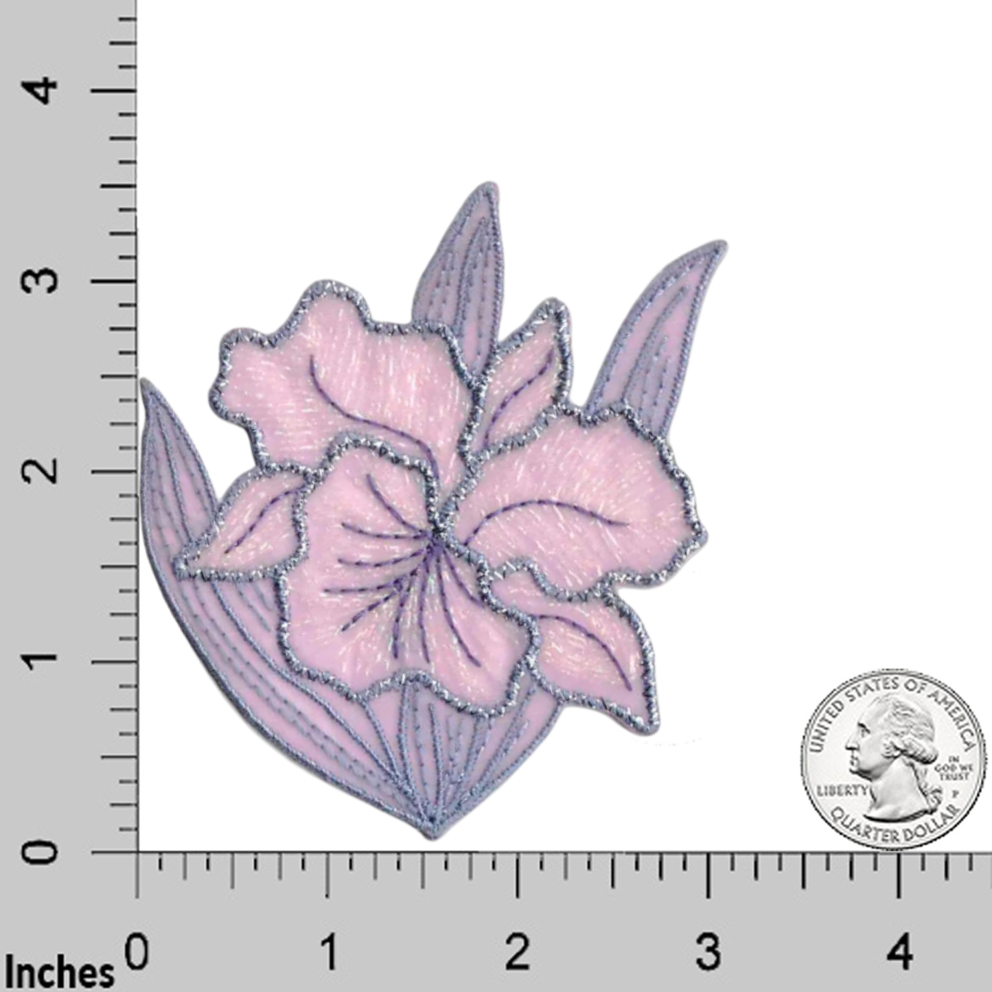 The Iridescent Flower in LAVENDER (2-Pack) Iron on Patch by Laughing Lizards, shown next to a U.S. quarter and an inch ruler, features embroidered lavender petals with green leaves and a metallic sheen.