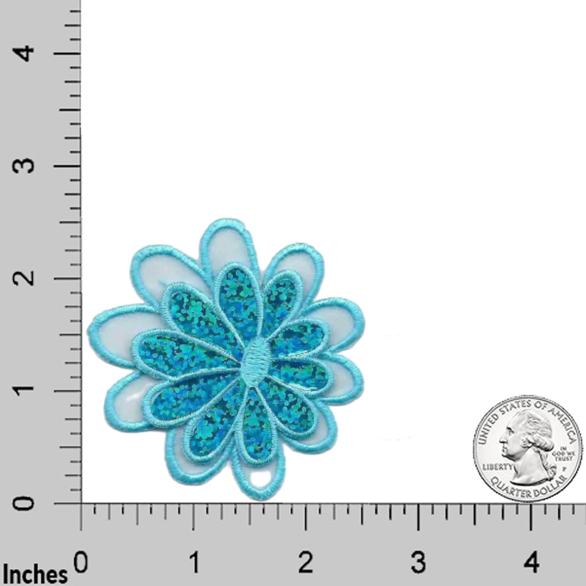 Laughing Lizards’ Sparkle Daisy in Blue (3-Pack) Iron On Flower Applique features blue and teal embroidered daisies, shown on a grid with inch markings and a U.S. quarter for size. Add charm and sparkle to any project!.