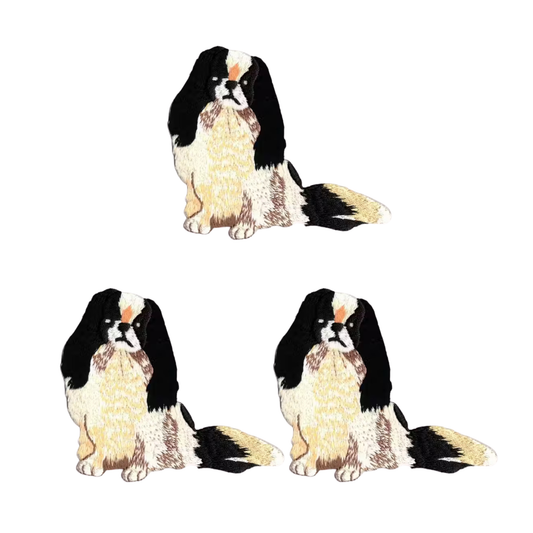 The LaughingLizards Japanese Chin Dog (3 Pack) Iron On Patch features three identical black, white, and tan dogs with fluffy tails arranged in a triangle on a white background—perfect for adorable decoration.