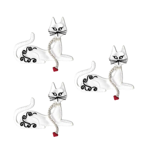 The Laughing Lizards Satin Small White Cat (3-Pack) Iron On Patch features adorable white cats with black details and red heart-tipped curled tails—perfect cat appliques for kids' clothing or cute accent patches.