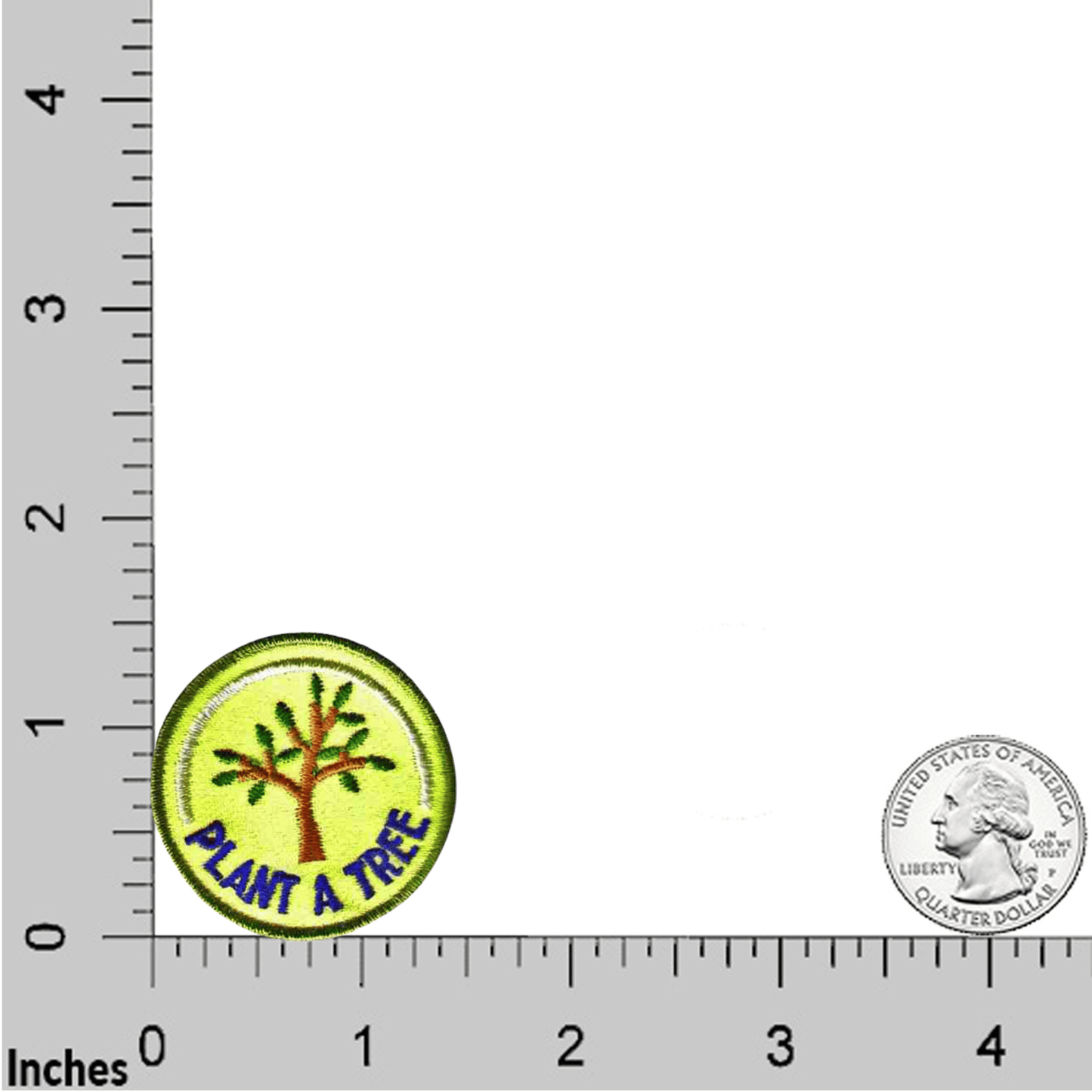 A round embroidered Laughing Lizards "Plant A Tree (5-Pack) Iron On Patch" is shown near the 1-inch mark on a ruler, with a U.S. quarter beside it for size comparison.