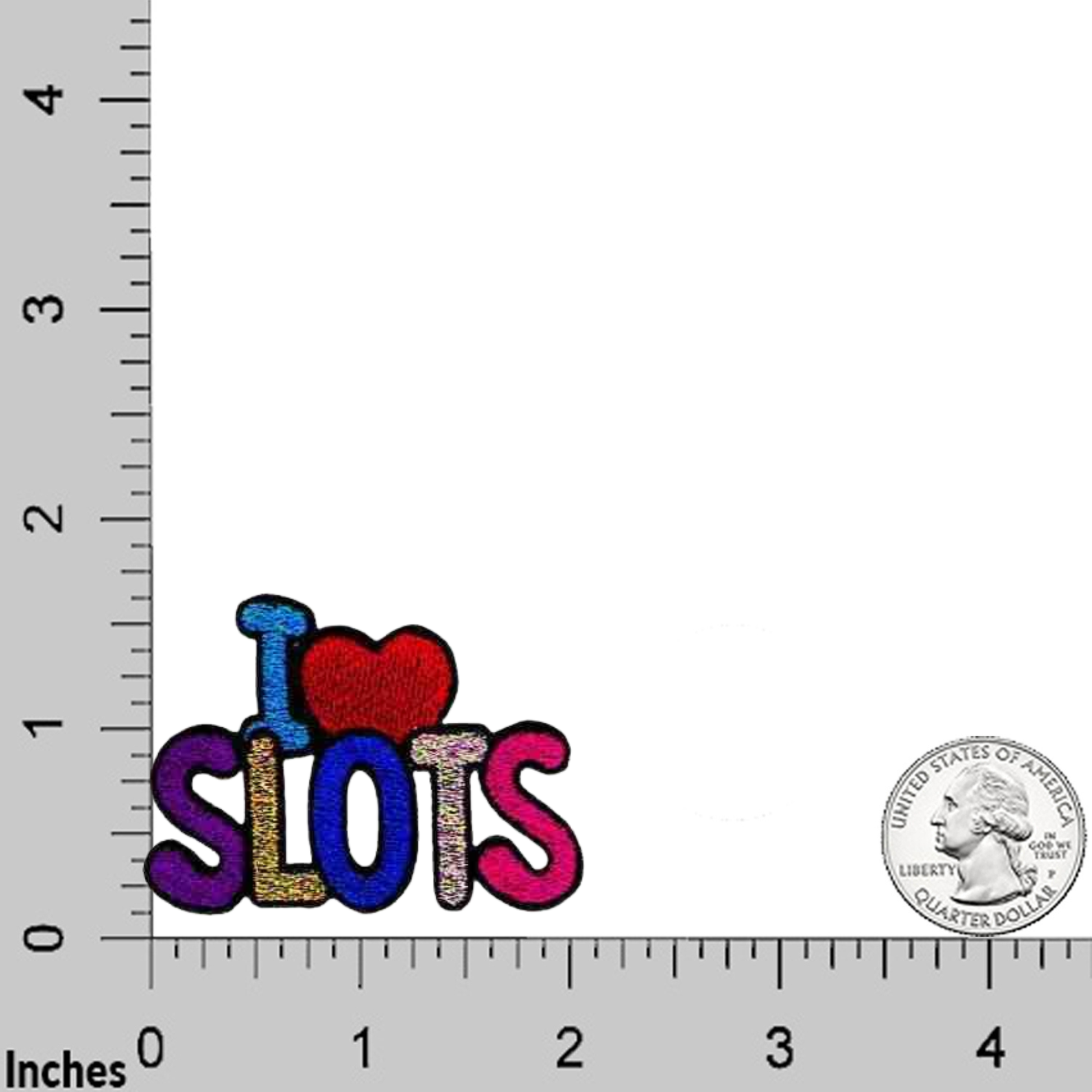 The Laughing Lizards I HEART Gambling (3-Pack) Iron On Patch, featuring "I ♥ SLOTS," is shown on a grid with inch measurements and a U.S. quarter for size reference.