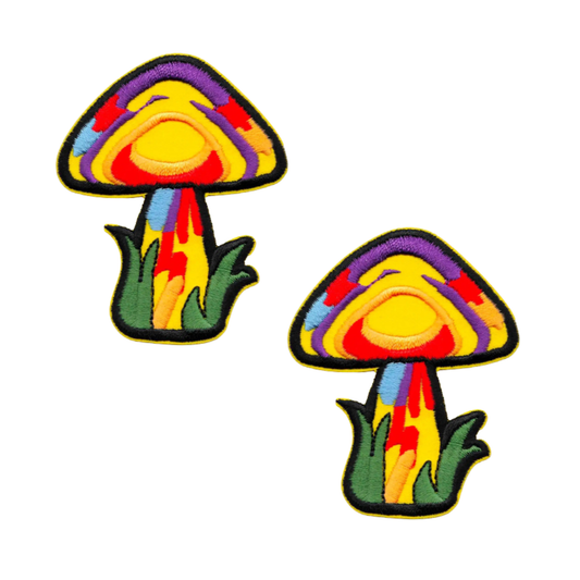 The LaughingLizards Magic Mushroom (2-Pack) Iron On Patch features colorful embroidered mushrooms with rainbow patterns and green grass, ideal for customizing jackets, bags, or hats. Displayed on a white background.