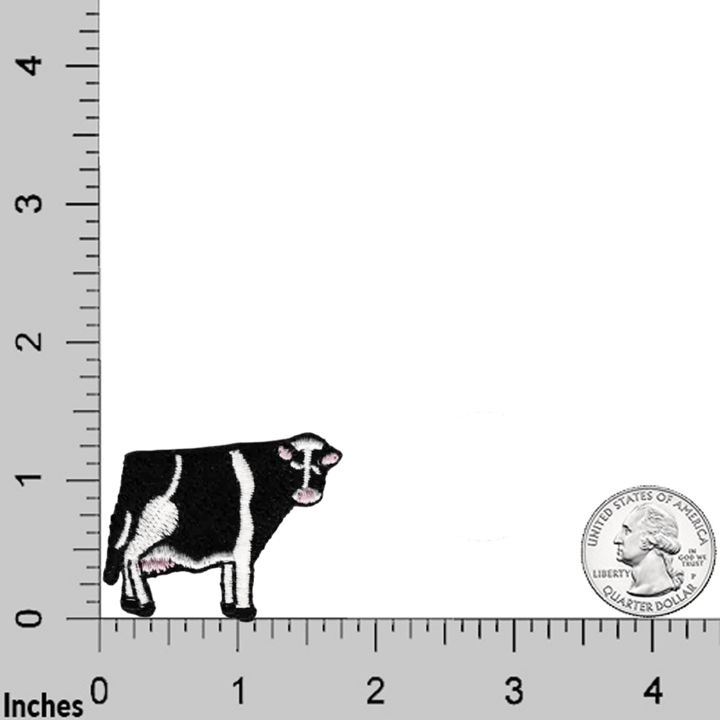 A Tiny Cow Patches (5-Pack) Farm Animal Embroidered Iron On Patch Appliques is standing next to a ruler.