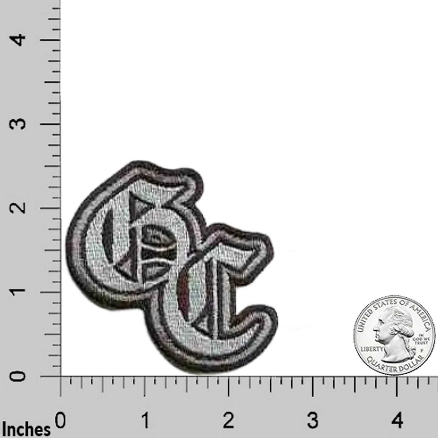 The LaughingLizards Good Charlotte Logo Band Iron On Patch features embroidered "GC" letters in a stylized font, displayed on a grid with inch markings and a US quarter for scale. Ideal for fans and collectors of Good Charlotte band patches.
