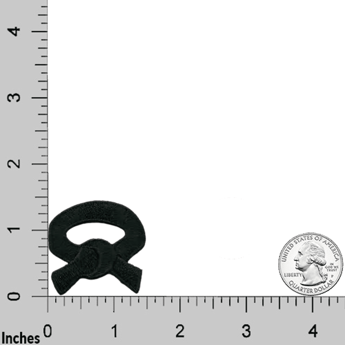The Laughing Lizards Black Belt (5-Packs) Embroidered Iron On Patch is shown ribbon-shaped next to a U.S. quarter for scale on a grid marked in inches.
