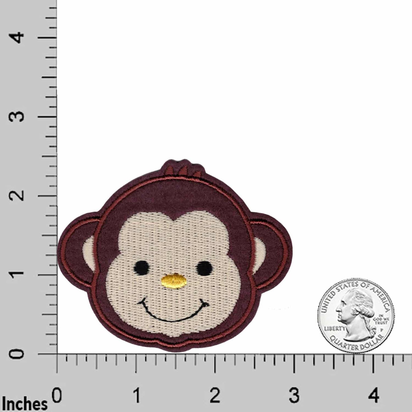 The Laughing Lizards Cute Monkey (2-Pack) Embroidered Iron on Patch Applique is shown between a ruler and a quarter for size reference—ideal for DIY crafts.