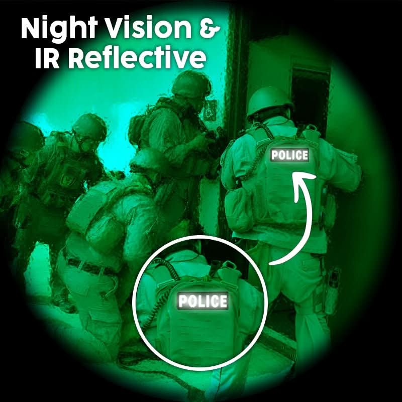 Five armed officers in tactical gear enter a building at night, "POLICE" visible on a Laughing Lizards Fire Patch—an ultra reflective hook and loop patch for tactical vests—highlighted by night vision and infrared reflectivity.