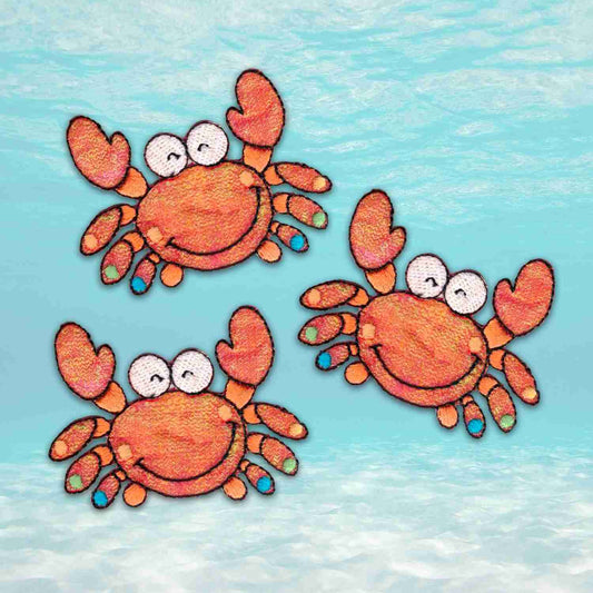 Three Crab Patches (3-Pack) Sea Animal Embroidered Iron Patch Appliques floating in the water.