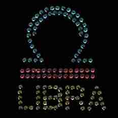The Rhinestud Libra Zodiac Sign Iron On Applique is made of colored crystals.