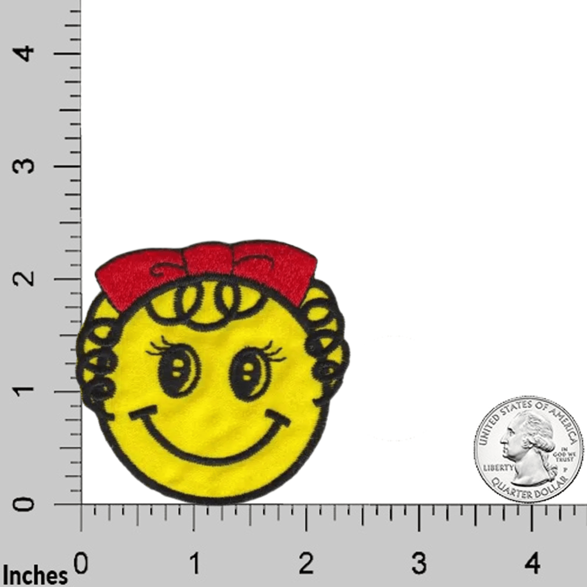 The Laughing Lizards Smiley Face Girl Patch with Curly Hair and Red Bow (3-Pack) is an iron on patch, about 2 inches wide, featuring a cute yellow smiley face with a red bow—shown on a grid with a U.S. quarter for scale.