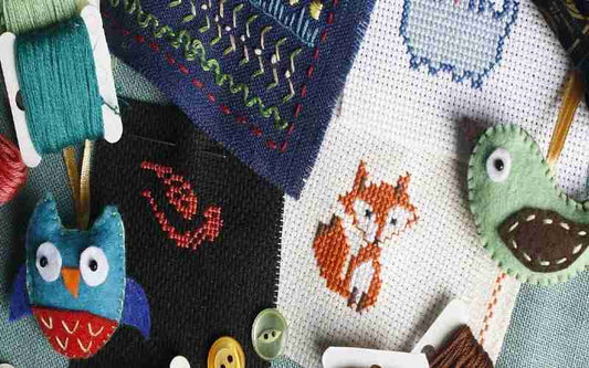 A cross stitch kit with owls, foxes and other animals.