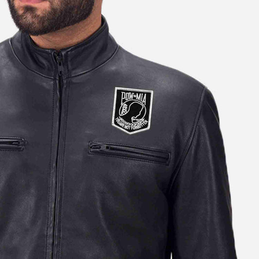 A man wearing a black leather jacket with a POW-MIA Military Style Small Iron On Patch on it.