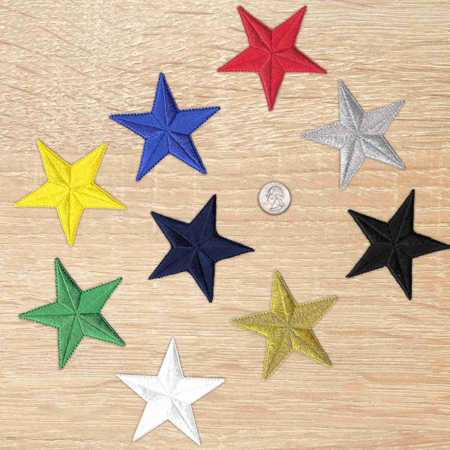 Five 3 Inch Iron on Star Patches (5 Pack) appliques on a wooden table.