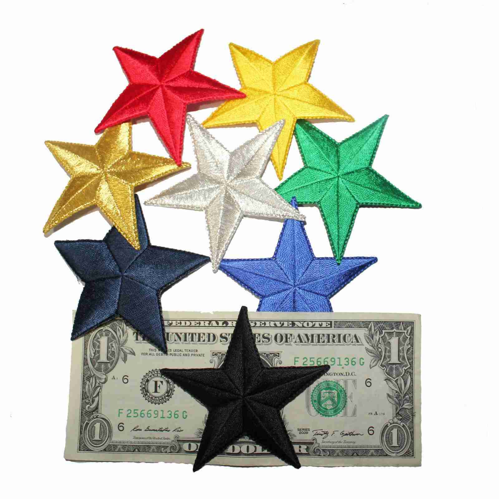 A group of 3 Inch Iron on Star Patches (5 Pack) shaped appliques on top of a dollar bill.