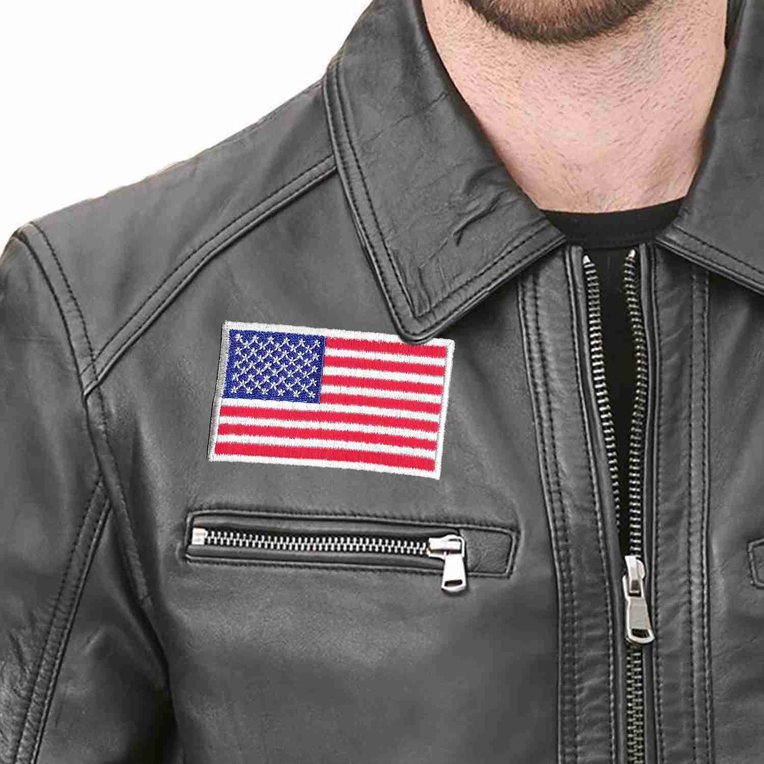 A man wearing a black leather jacket with USA Flag Patches (2-Pack) American Flag Embroidered Iron On Patch Appliques.