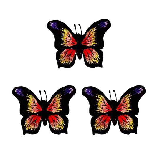Three LaughingLizards Black, Yellow & Orange Butterfly Iron On Patches (3 Pack) are displayed in a triangular arrangement on a white background.