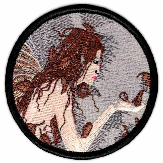 A Pirate Skull with crossbones Iron on Patch with an image of a woman holding a butterfly.