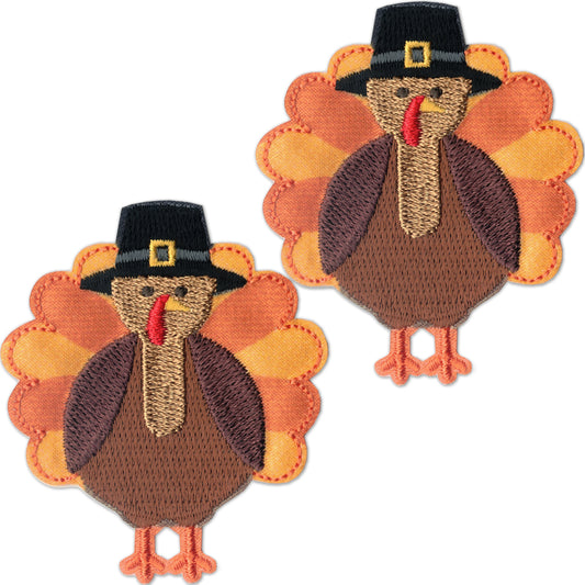 Laughing Lizards Turkey Patches (2-Pack) are embroidered iron-on appliques featuring brown bodies, orange tail feathers, and black pilgrim hats—perfect for festive Thanksgiving decor.