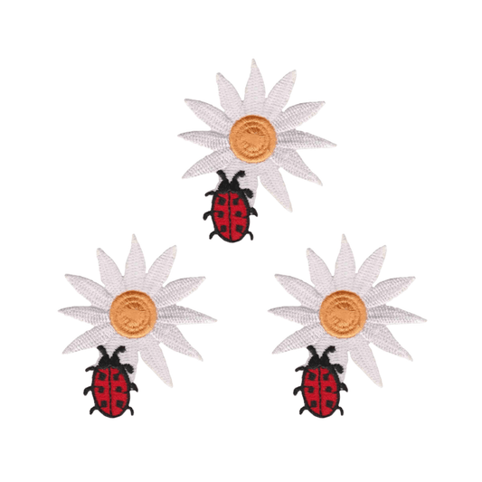 The Laughing Lizards Daisy with Ladybug (3-Pack) Iron On Patch features white daisies with yellow centers paired with red and black ladybugs—ideal for DIY craft appliqué on a white background.