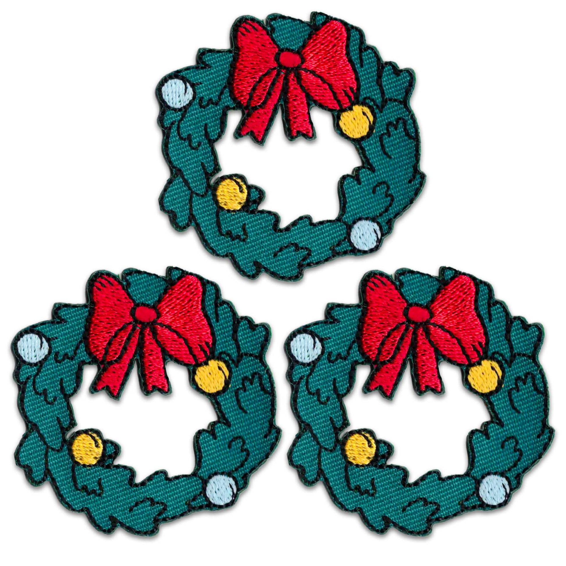 The Laughing Lizards Christmas Wreath (3 Pack) features festive iron-on embroidered patches with red bows, yellow and white ornaments, and green leaves—perfect for holiday crafts or decorations.