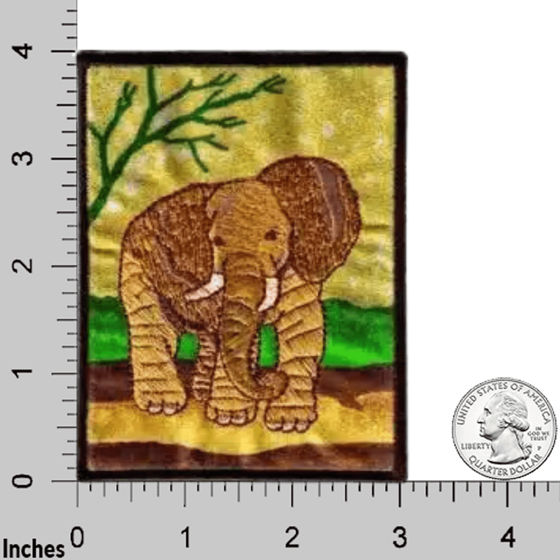 The Laughing Lizards Elephant in Natural Environment Jungle Iron On Patch is a rectangular patch featuring an embroidered elephant standing on grass, shown next to a ruler and U.S. quarter for size reference.