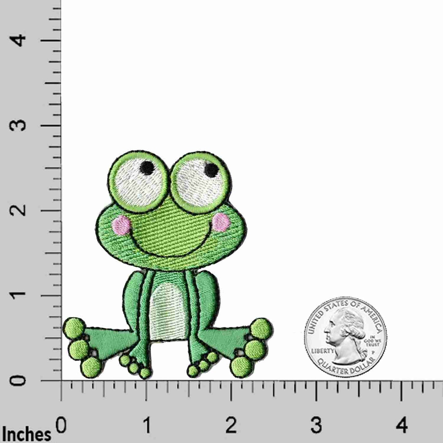 A green Frog Patches (2 Pack) Animal Embroidered Iron on Patch Appliques is sitting next to a ruler.