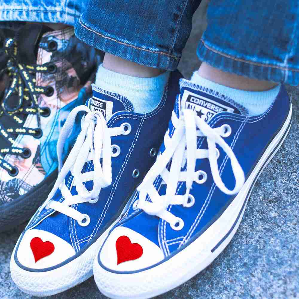 A pair of Heart Embroidered Iron on Patch (5-Pack) with hearts on them.