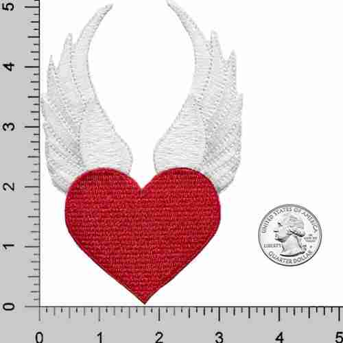 A red Winged Heart Iron On Patch on a ruler.