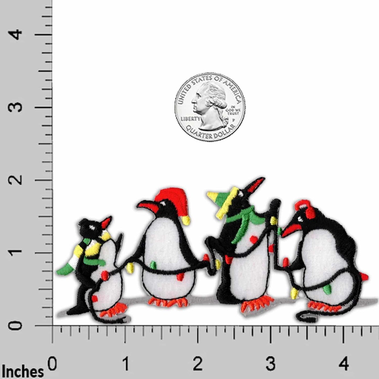 Four Penguins Patches (2-Pack) Christmas Embroidered Iron On Patch Appliques wearing christmas hats are standing next to a ruler.