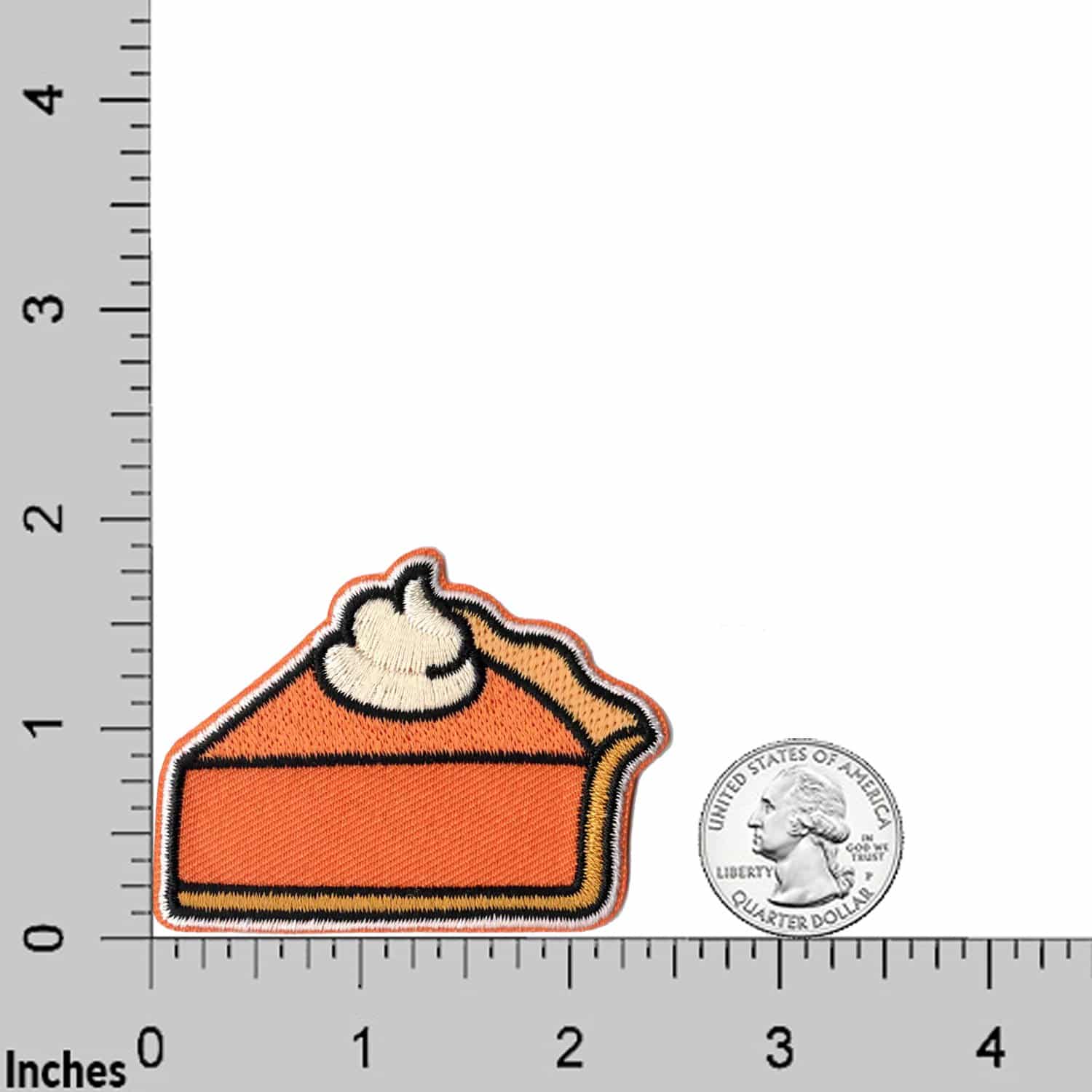 A Pumpkin Pie Patches (2-Pack) Thanksgiving Embroidered Iron On Patch Appliques embroidered on a ruler.