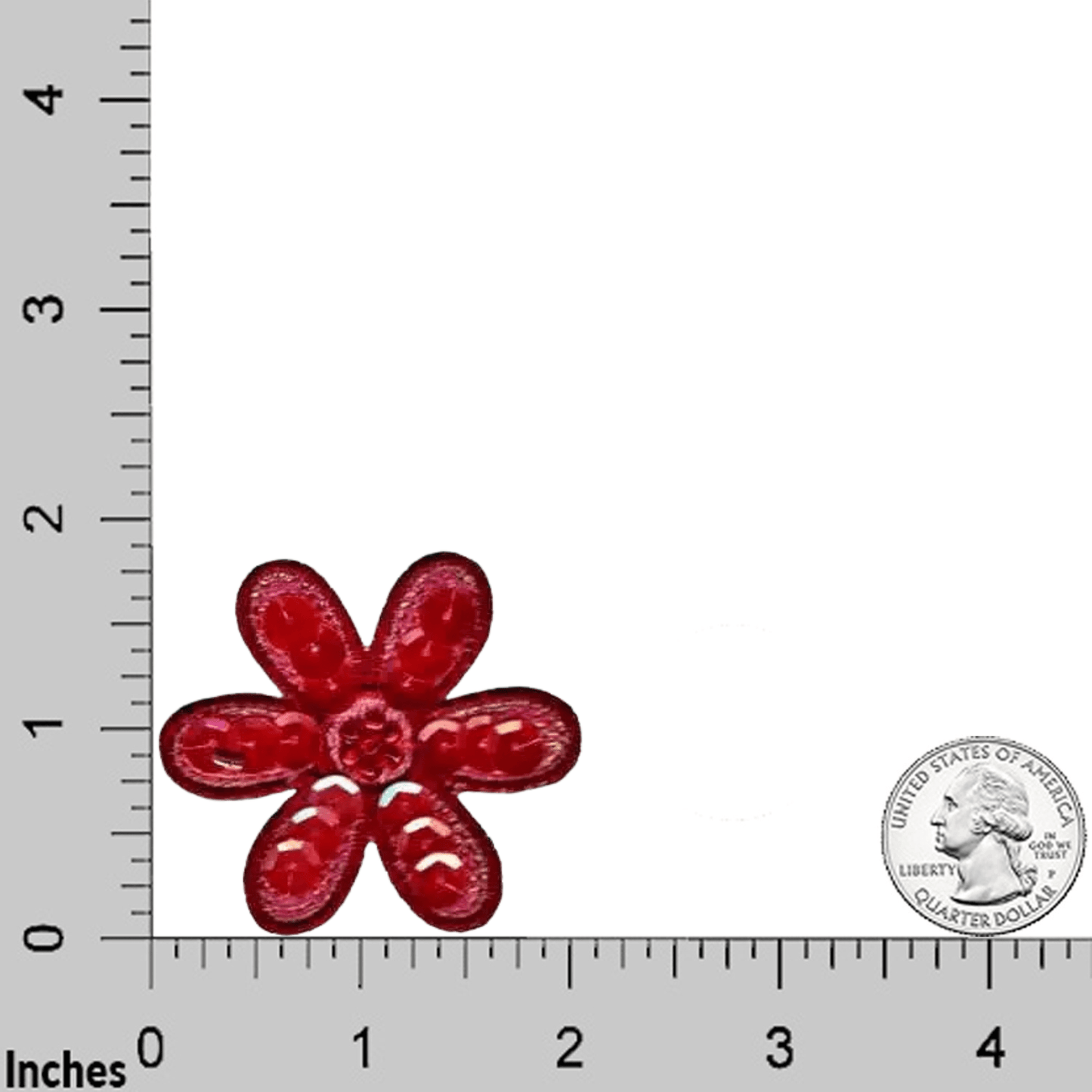 A Sequin Daisy (3-Pack) Iron On Floral Patch by Laughing Lizards, shaped like a flower, is displayed near a U.S. quarter on a surface with inch measurements along the edges.