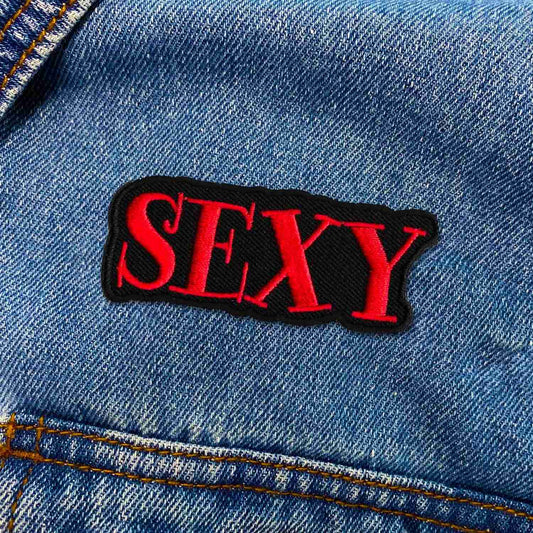 A Sexy Namedrop Iron On Patch with the word sexy on it.
