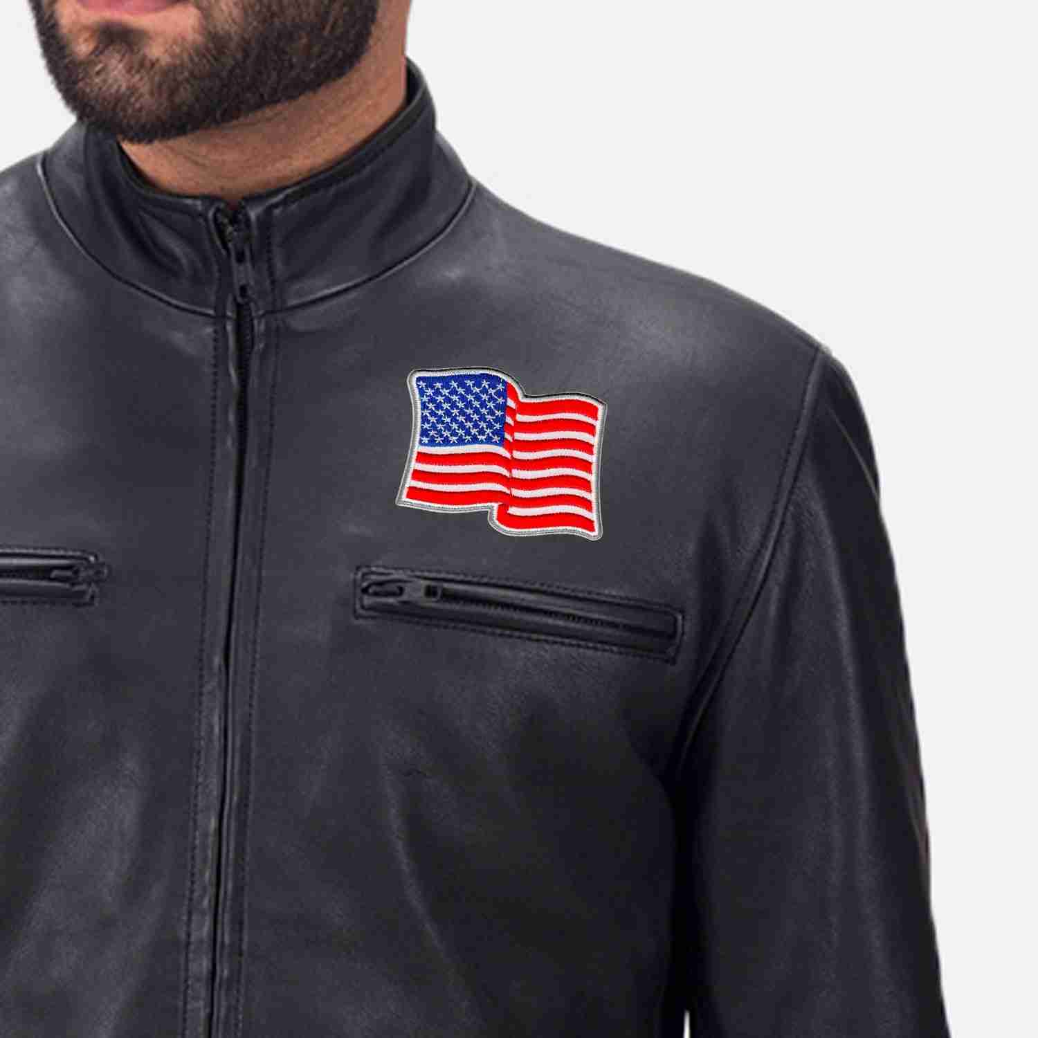 A man wearing a black leather jacket with Waving USA Flag Patches (2-Pack) American Flag Embroidered Iron On Patch Appliques on it.